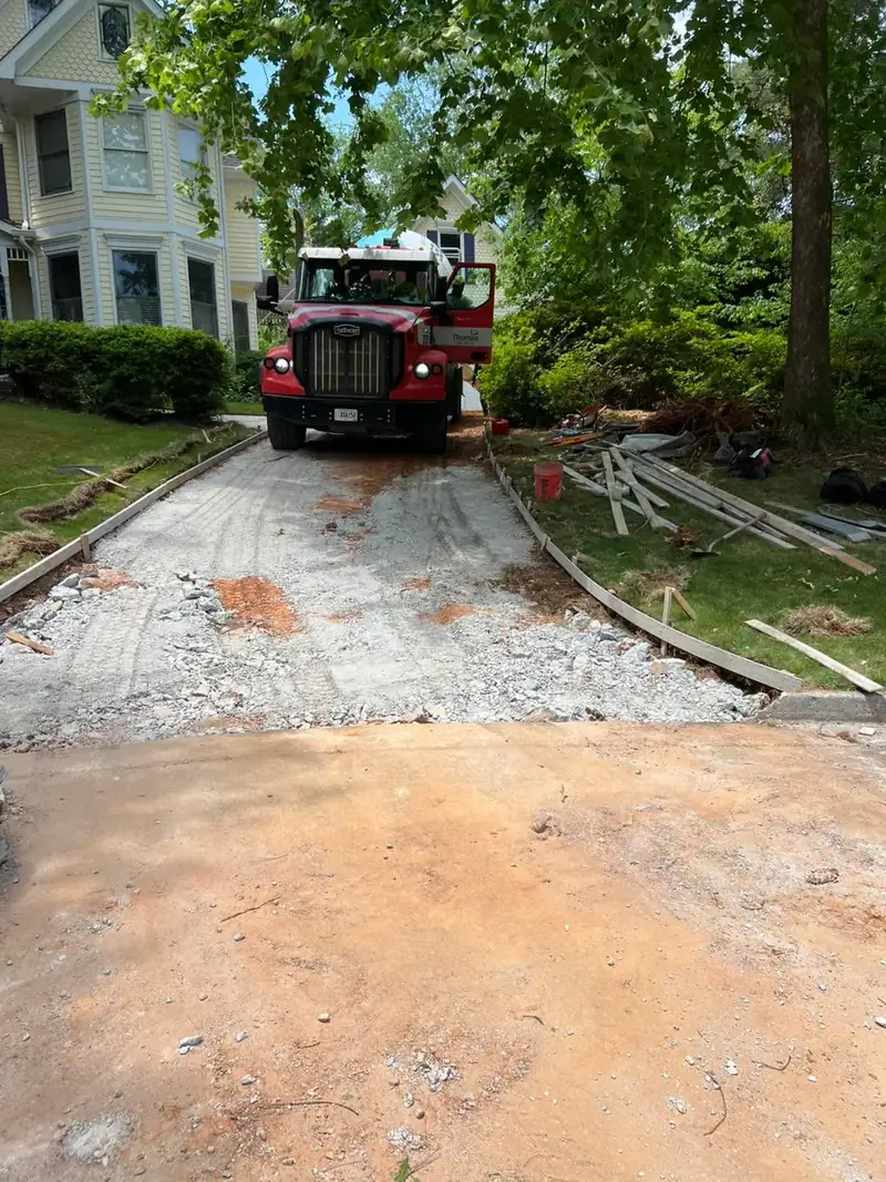 Concrete mixer truck backing up to a graded and formed driveway
