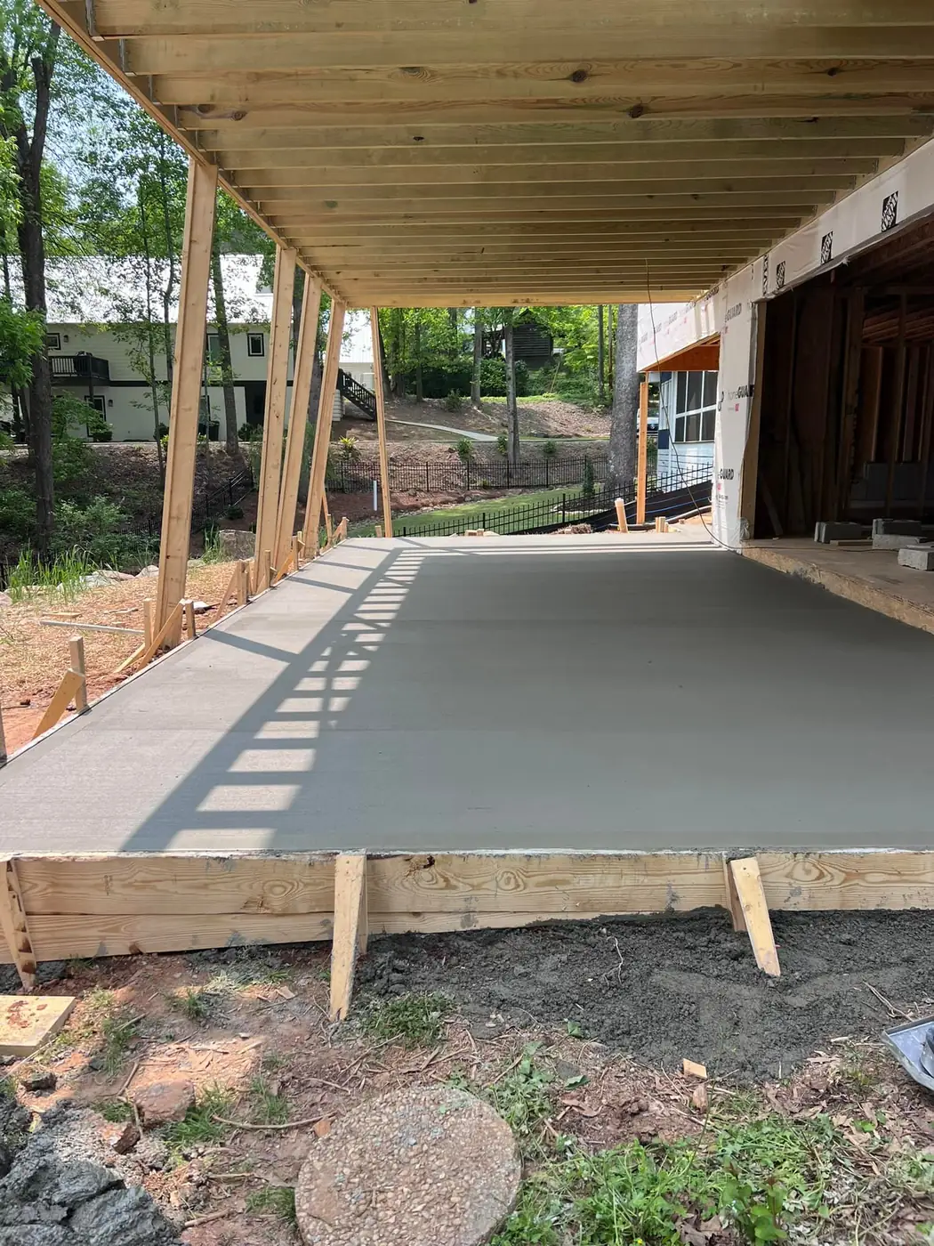 New covered porch framing over a concrete slab